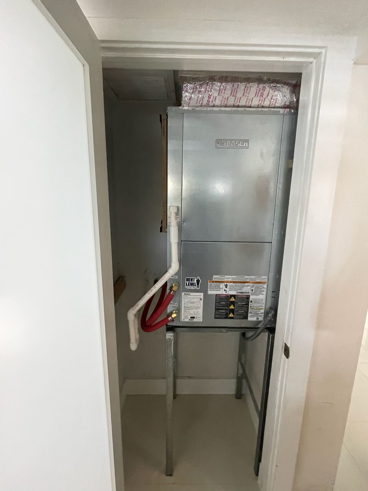 Air handler on a stand in a closet
