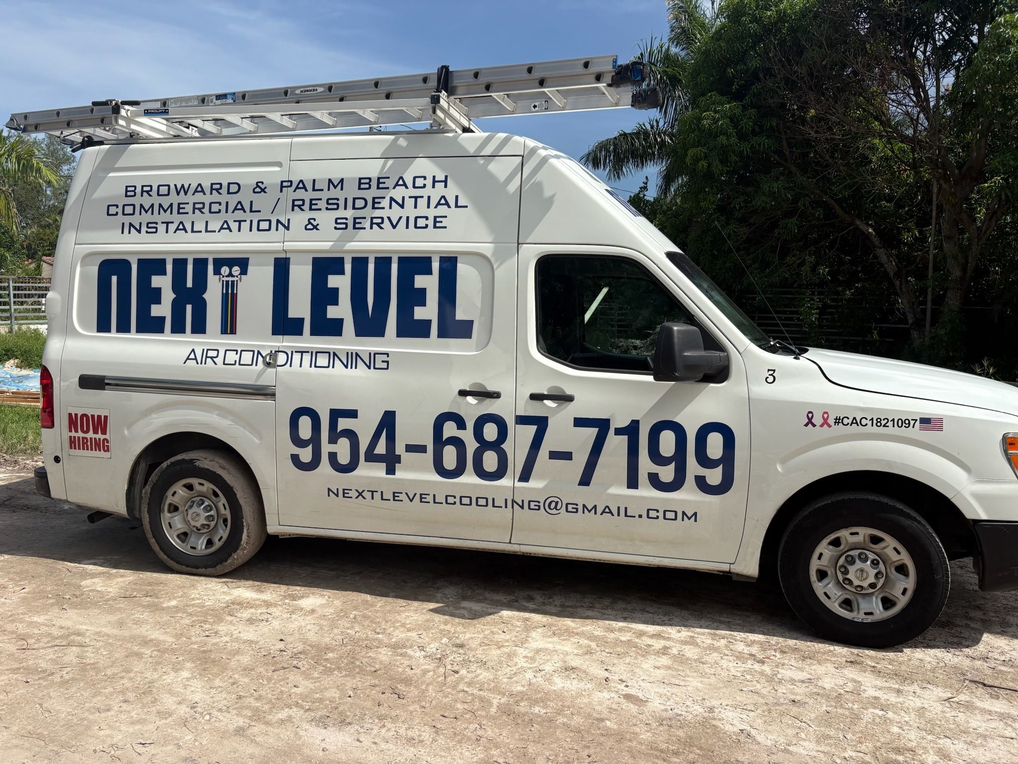 Next Level Air Conditioning service van parked on a job site