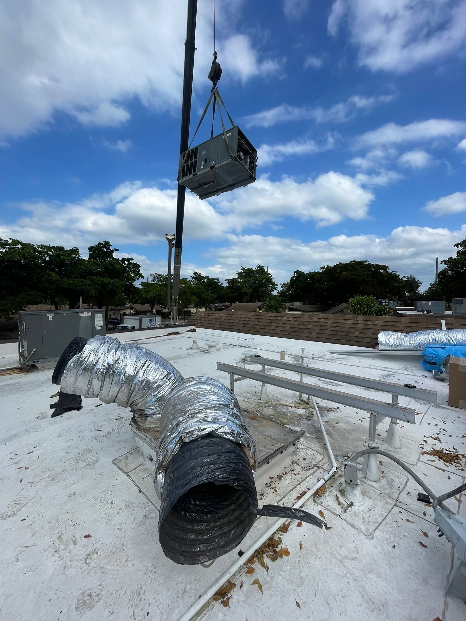 Crane setting a rooftop unit on a commercial roof, Next Level Air Conditioning job in Hollywood, 2023