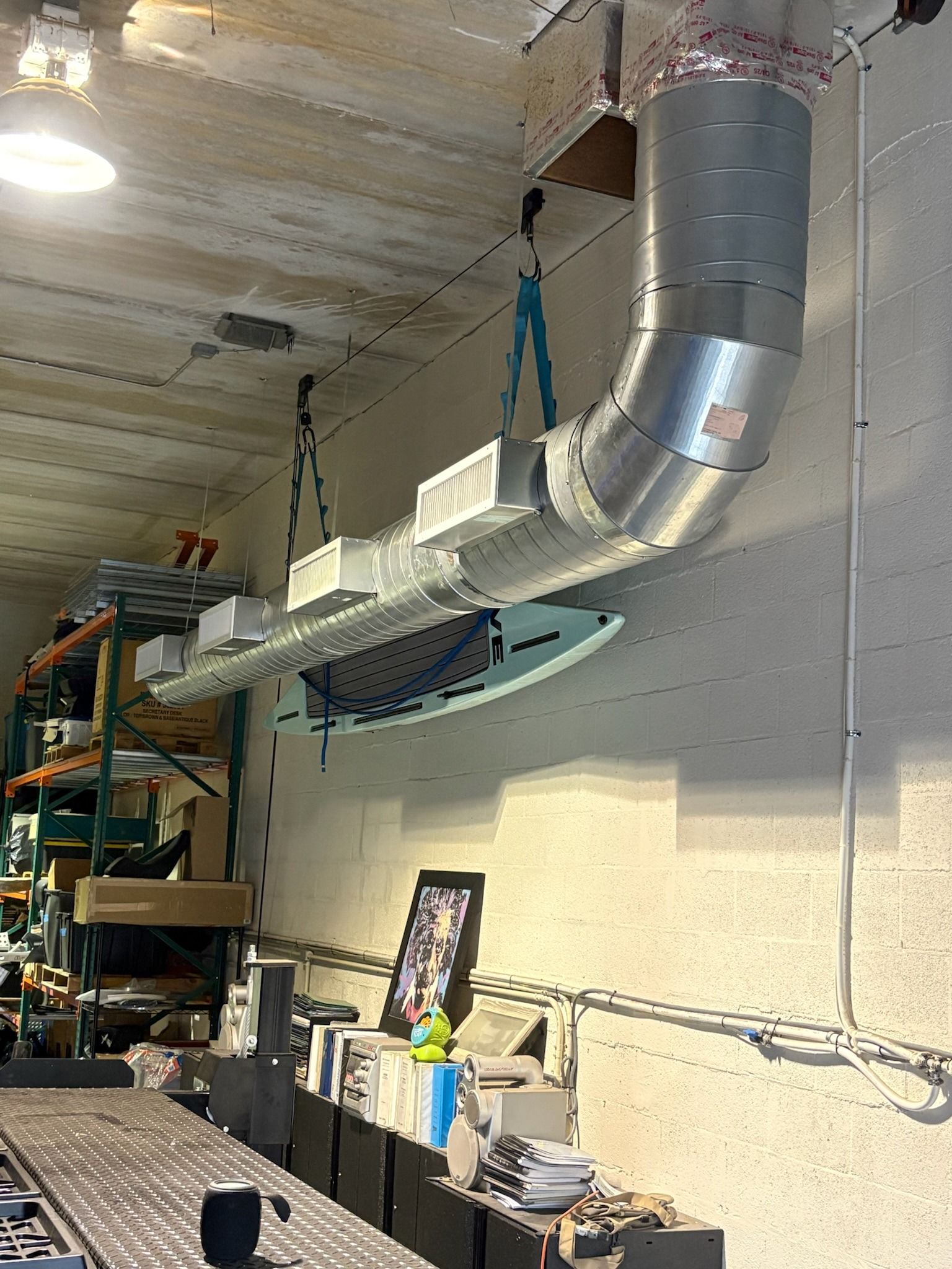 Exposed spiral duct with supply grilles in a warehouse, Next Level Air Conditioning job in Fort Lauderdale, 2026