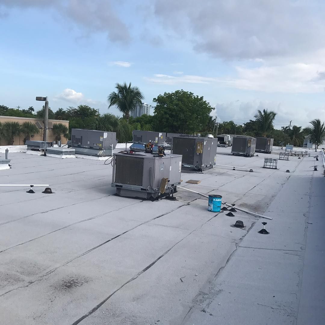 Large flat roof carrying a row of packaged rooftop units