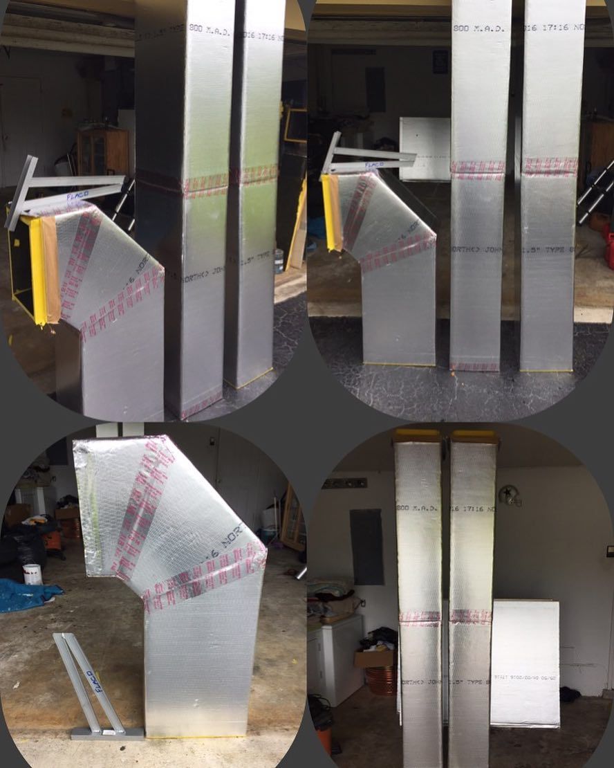 Hand fabricated insulated duct board offsets and transitions standing in the shop