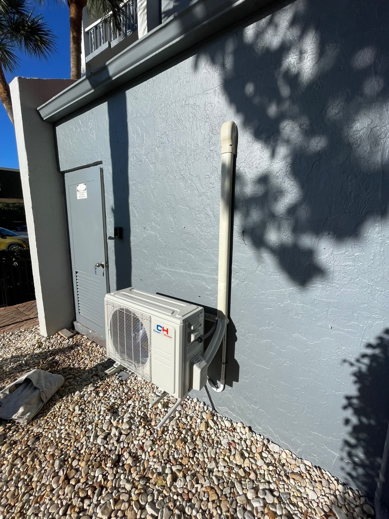Mini-split outdoor unit mounted on a block wall, Next Level Air Conditioning job in Lake Worth, 2024
