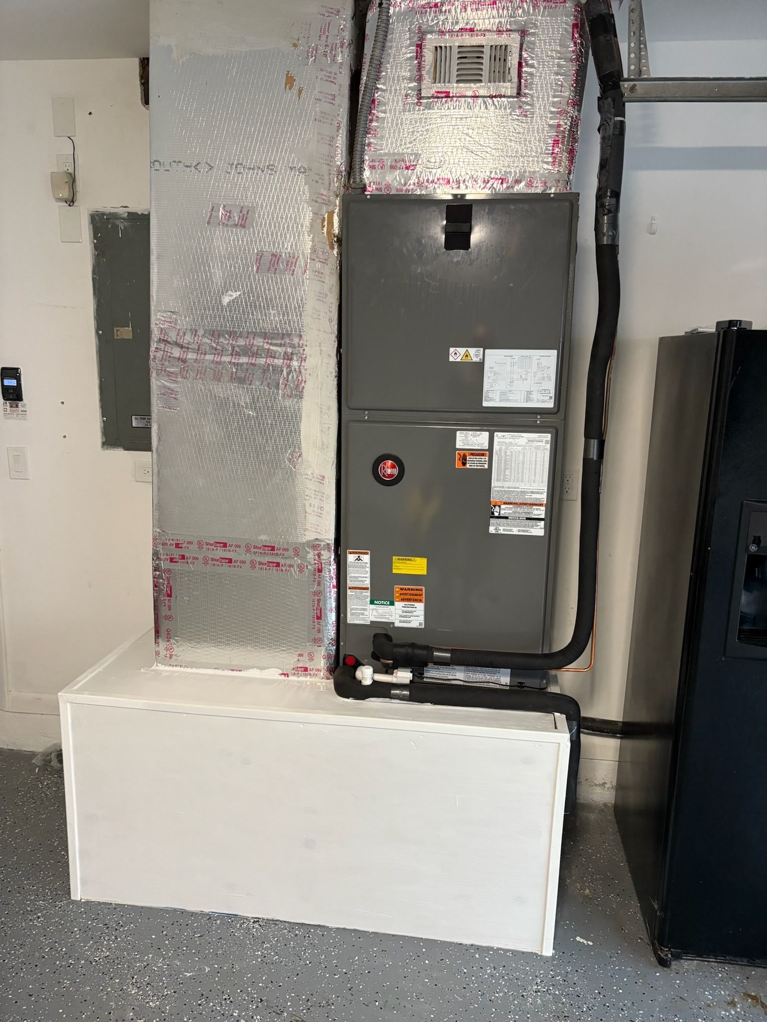 Rheem air handler on a platform in a garage, Next Level Air Conditioning job in west Boca, 2025