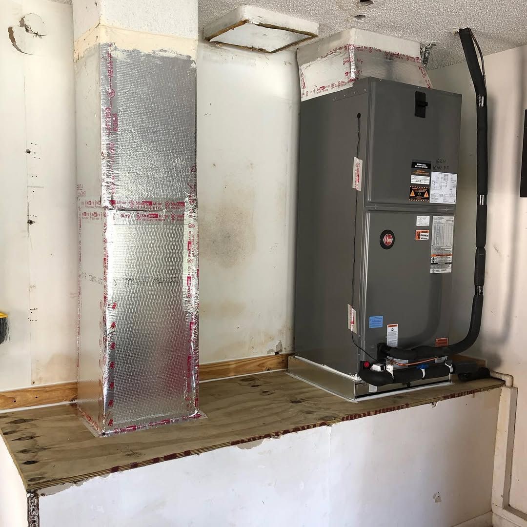 Rheem air handler on a plywood platform with an insulated return riser