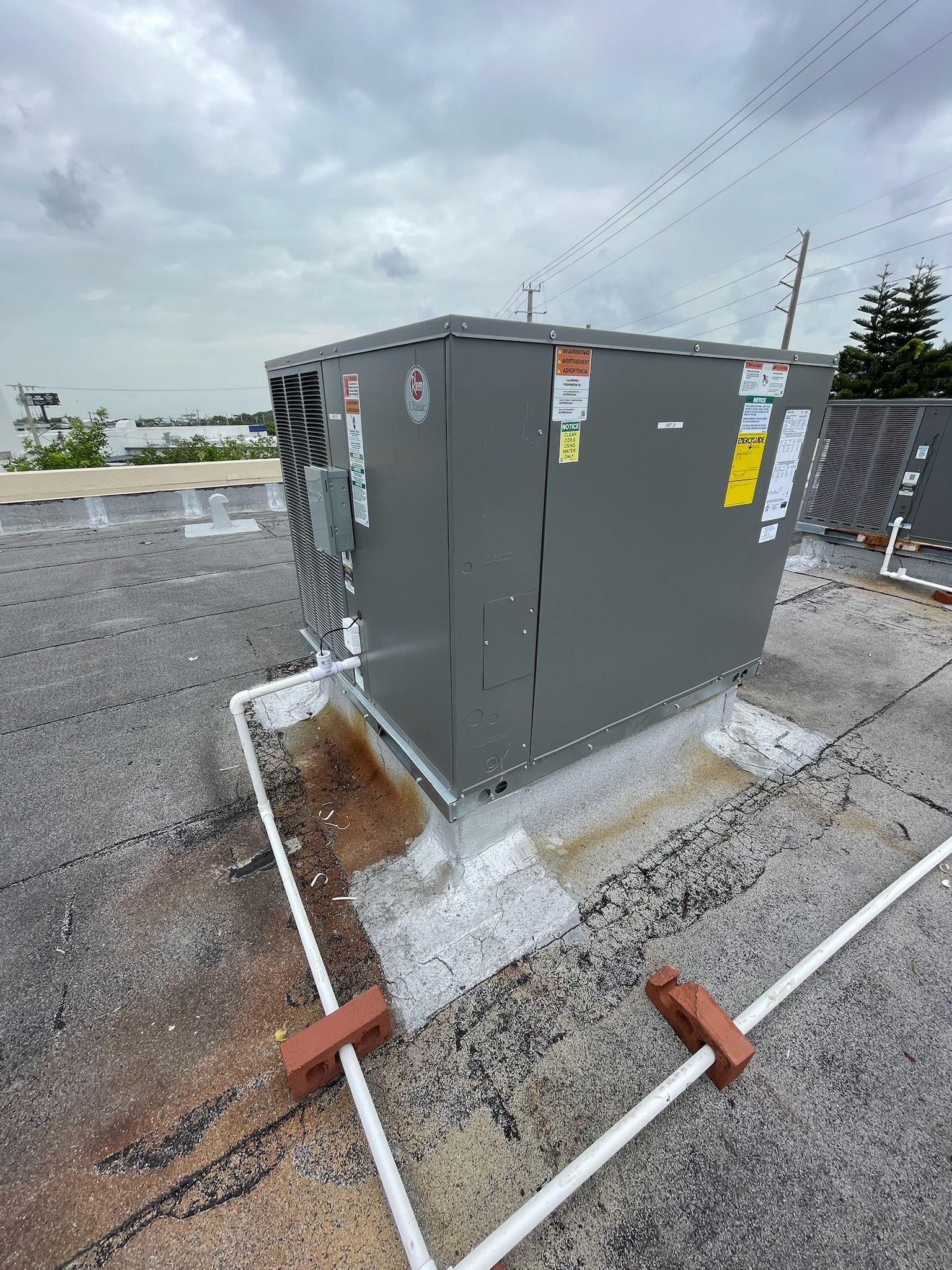 Rheem rooftop unit on a flat roof, Next Level Air Conditioning job in Fort Lauderdale, 2024