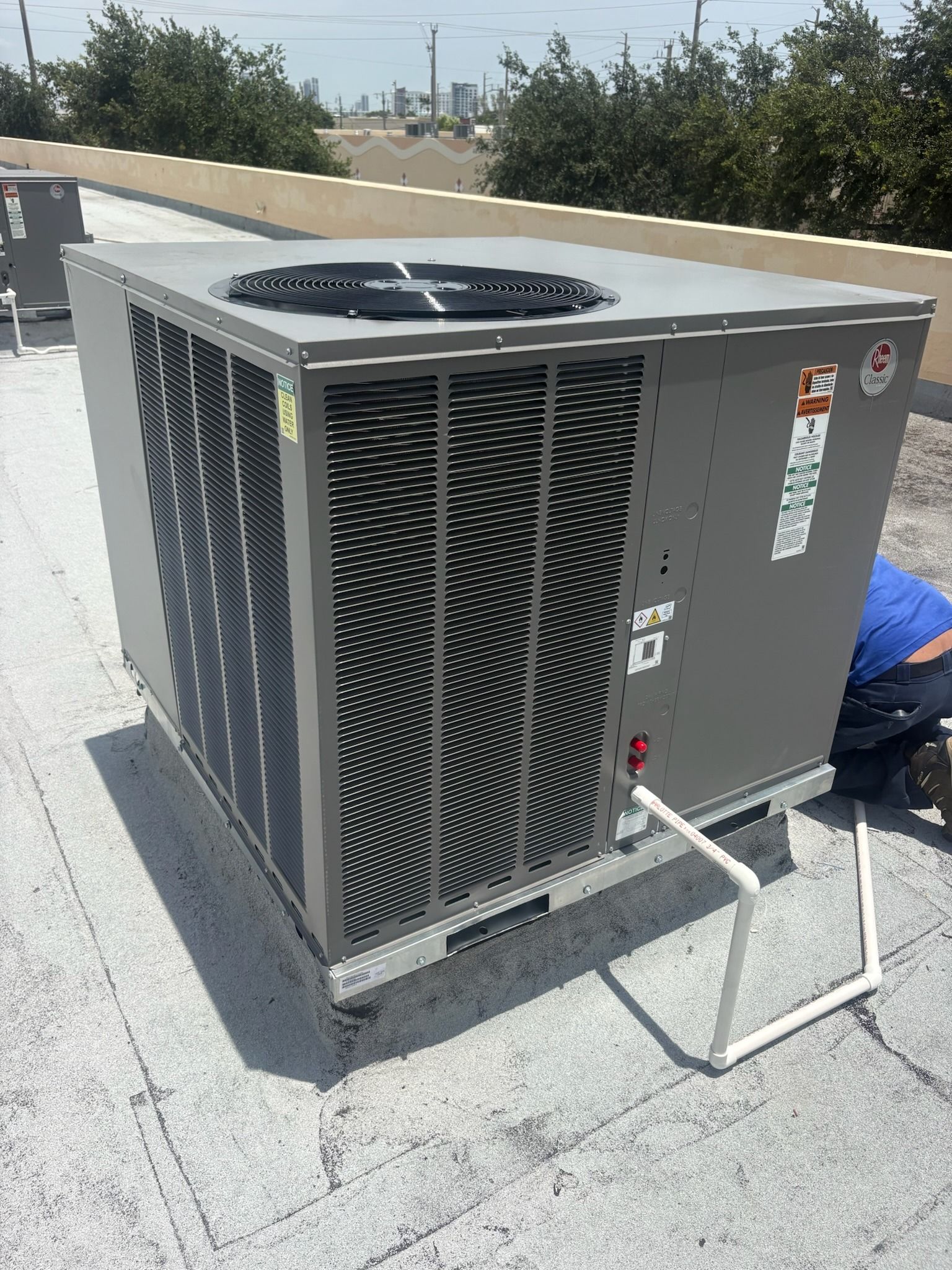 Rheem packaged rooftop unit on a flat commercial roof, Next Level Air Conditioning job in Fort Lauderdale, 2026