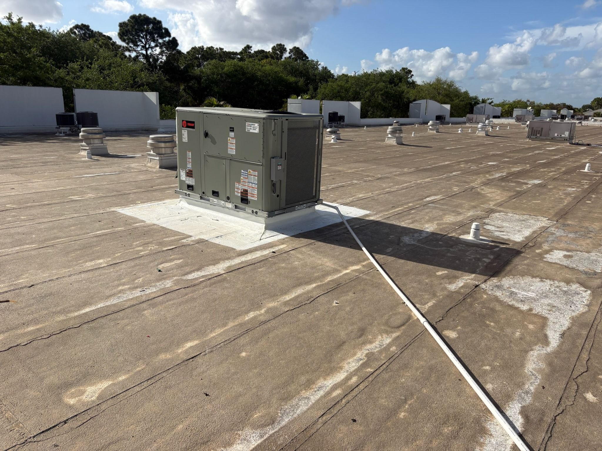 Commercial rooftop package unit on a flat roof in Coconut Creek