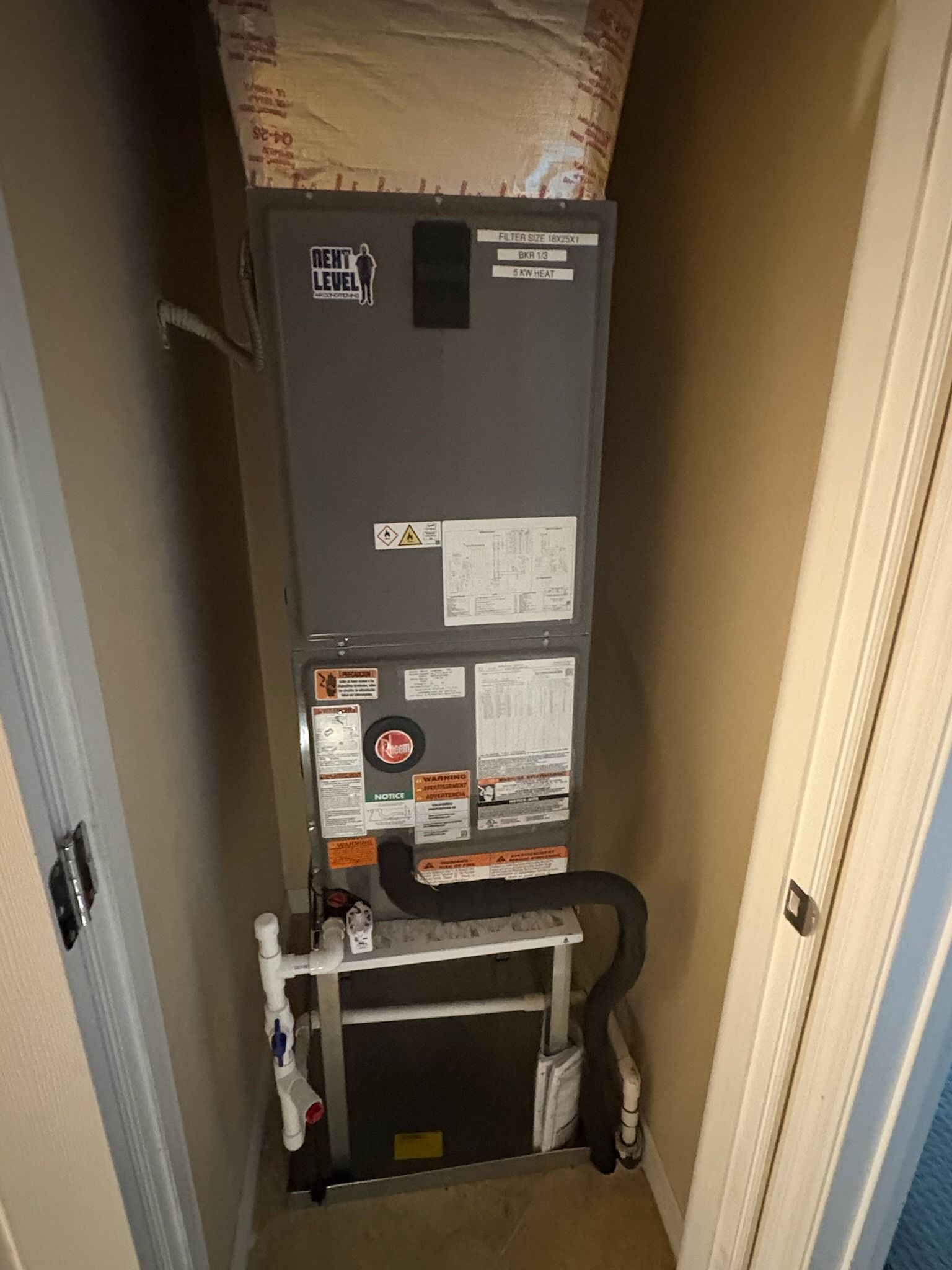 Second Rheem air handler on a stand in a closet, Next Level Air Conditioning job in Lake Worth, 2026