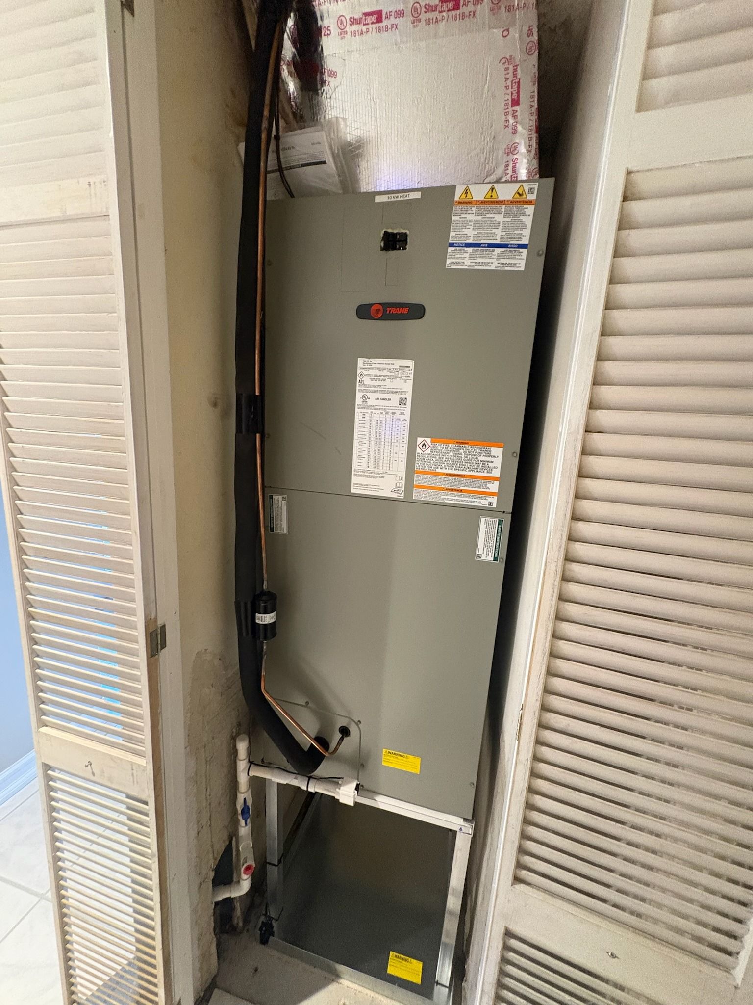 Trane air handler in a louvered closet, Next Level Air Conditioning job in Pembroke Pines, 2026