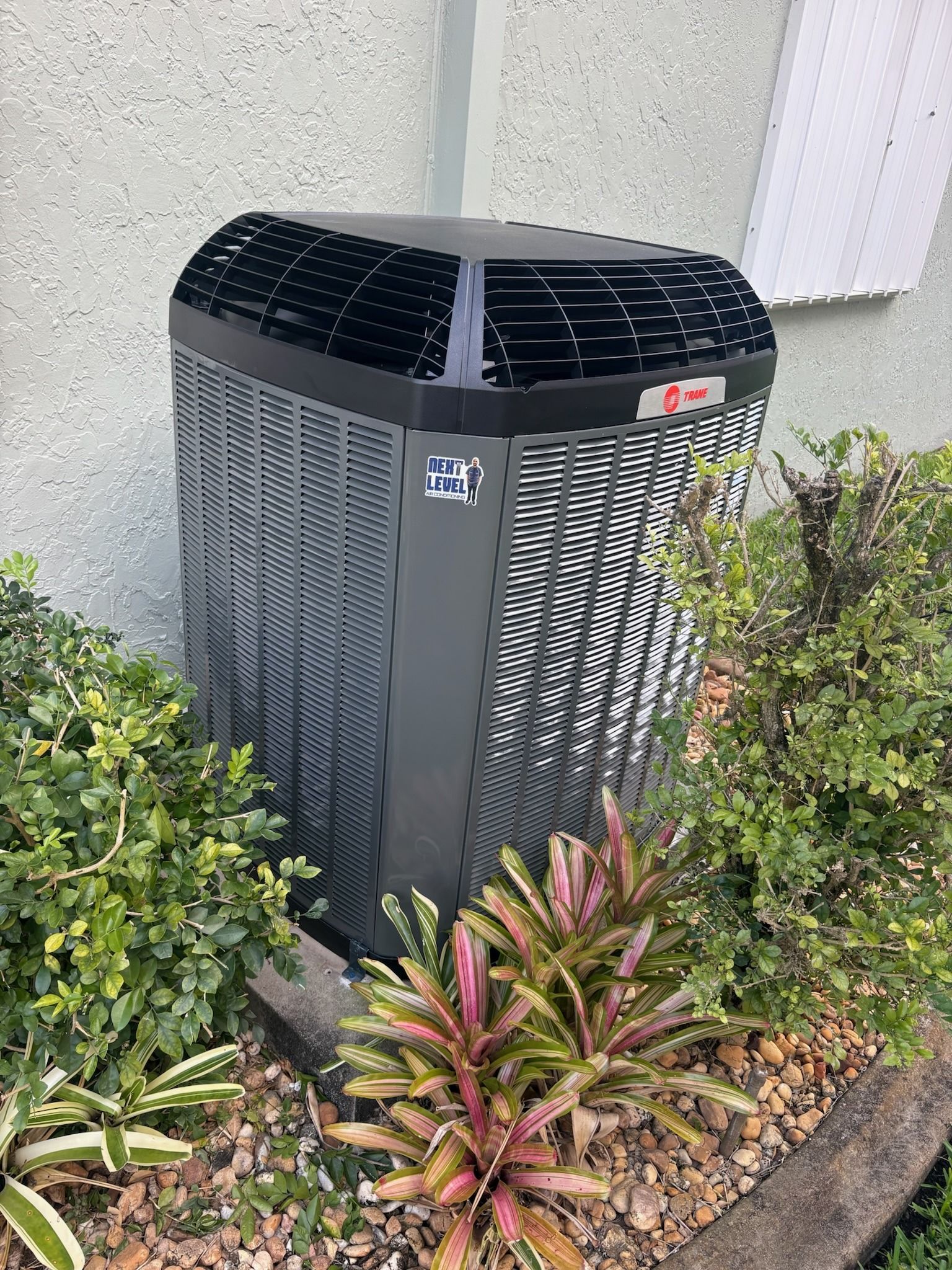 Trane XL condenser beside a home, Next Level Air Conditioning job in Pembroke Pines, 2026