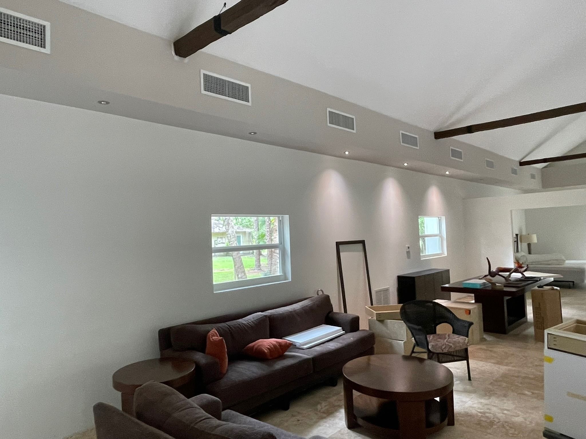 Row of supply grilles high on the wall of a vaulted living room, Next Level Air Conditioning job in Loxahatchee Groves, 2023
